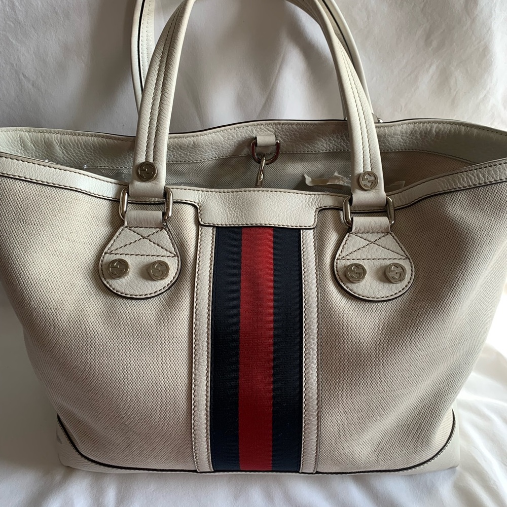Gucci Stylish Cream Tote Bag with Red and Black Web with silver tone hardware.